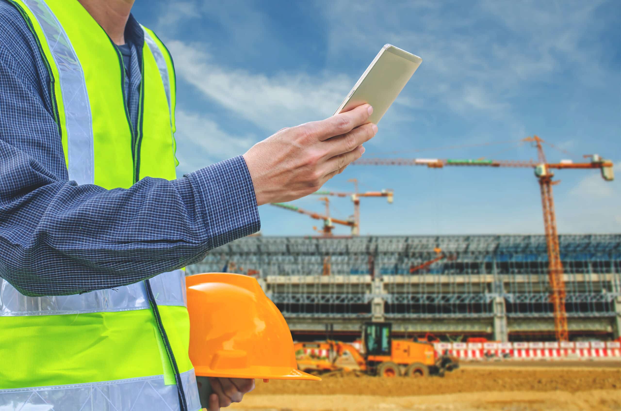 man at a construction site with tablet